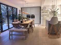 an open kitchen and dining room with sliding glass doors leading to the outside deck area