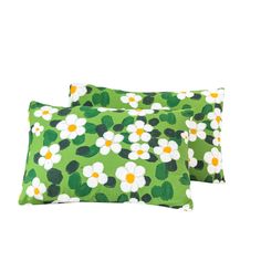 two green and white pillows with flowers on them