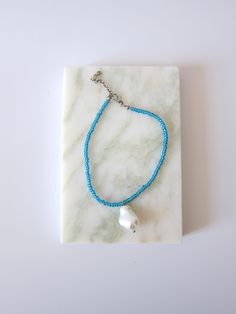 glass beaded anklets in both blue and clear with a tear drop fresh water pearl adjustable size made in Italy The perfect summer accessory to compliment your look~