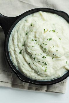 a black skillet filled with mashed potatoes