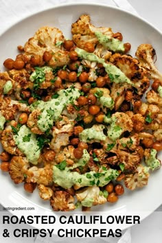 roasted cauliflower and crispy chickpeas with avocado dressing on a white plate