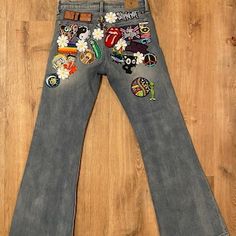 Hippie Fitted Wide Leg Flare Jeans, Trendy Wide-leg Flare Jeans For Festivals, Trendy Wide Leg Flare Jeans For Festival, Hippie Style Fitted Jeans, Fitted Hippie Jeans, Retro Wide Leg Patchwork Jeans, Trendy Fitted Jeans With Patches, Hippie Fitted Denim Jeans, Trendy Fitted Bottoms With Patches