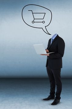 a man in a suit holding a laptop with a shopping cart speech bubble above his head