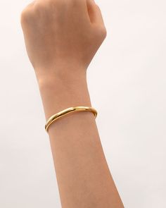 This bracelet features a classic bangle touched by the inspiration of life’s ups and downs, finished with a wavy shape that is concise and easy, encouraging people that - feel the changes and embrace them with no fear anymore. Classic silhouettes with wavy detailing give this ring versatility, ideal for stacking with other bracelets and jewelry in “The Wavy” collection or just worn solo.
 
Band Width: 6mm
Band Thickness: 2.5mm
Material: 18k Gold Plated On Brass Classic Bangle Bracelets For Friendship, Classic Friendship Bangle Bracelets, Modern Everyday Bangle With Bracelet Strap, Adjustable Bangle With Polished Finish For Everyday, Minimalist Cuff Bracelet With Oyster Design, Elegant Jubilee Cuff Bracelet For Friendship, Minimalist Cuff Bangle With Polished Finish, Modern Bangle Bracelets, Modern Everyday Bangle Bracelets