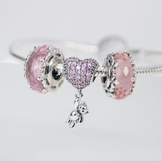 This is charm only, bracelet is sold separately. Bring some extra joy and sparkle to your Valentine's Day with this exquisite heart and teddy bear combo charm. Perfect for adding to a bracelet or necklace, this solid 925 sterling silver charm features a dazzling pink cubic zirconia pave heart and a tiny teddy bear for a touch of cuteness. Show your love with this adorable charm, plated with shiny platinum to keep it shining for years to come. Materials: 925 sterling silver, cubic zirconiaFinish: platinum plateDimensions: 0.82 x 0.42 x 0.30 inHole size: 0.18 in Jewelry Care: See more information about how to care for your jewelry here. Shipping Policy: Orders will be shipped within 1-3 business days. Economy shipping will take 7-14 days to arrive and standard shipping is 1- 4 days for U.S. Cubic Zirconia Charm Bracelet Gift, Pink Heart-shaped Dangling Charms, Pink Heart Pendant Charms As Gift, Pink Charms For Valentine's Day, Pink Heart Charm Bracelet In Sterling Silver, Personalized Pink Sterling Silver Charm Bracelet, Pink Heart-shaped Sterling Silver Charm Bracelet, Personalized Pink Sterling Silver Charms, Pink Heart-shaped Jewelry With Dangling Charms