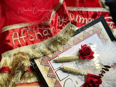 a red and gold wedding garb with feathers, flowers, and other items on it