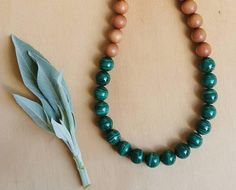 "A stunning set of ethnic style wooden beads.  This necklace is made up of beautiful, vibrant green  Malachite and Aromatic Sandalwood beads. Healing properties of Malachite 💚 Malachite is a beautiful heart chakra crystal, benefiting both the emotional and physcical heart.  It assists one in finding the joy in life.  It also benifits the solar plexus, promoting alignment and expression of both personal and divine will. Its energy reminds us that we are co creators in this world and that the pos Nature-inspired Green Jewelry With Wooden Beads, Green Polished Beads Mala As Gift, Green Polished Beads Mala For Gift, Gift Green Polished Beads Mala, Green Mala With Polished Beads As Gift, Traditional Green Necklace For Meditation, Traditional Green Necklace For Healing, Earthy Green Necklace With Wooden Beads, Green Spiritual Necklace With Wooden Beads