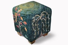 an artistically designed stool made out of wood with flowers and leaves painted on it