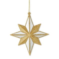 a gold and white star ornament hanging from a string