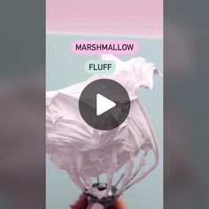 a person holding a white object with the words marshmallow fluff on it