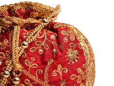 Red Potli Bag with Pearl Handle Strap An ideal for brides rocking the classic red bridal lehenga on their wedding with its classy zari work and a pearl handle strap all in gold the Dulhan Potli Bag is ready to beautify you. Fabric Raw Silk Color Red Embroidery Zari Work in Gold Size amp Dimensions Height - 8 inWidth - 7.5 inDepth - 1.5 in Strap Pearl Handle Strap Closure Tasseled Drawstring Compartments Single compartment Care Wipe with a soft clean amp dry cloth to remove dust When not in use s Red Bridal Lehenga, Bridal Mask, Potli Bag, Ethnic Bag, Bridal Lehenga Red, San Ramon, Potli Bags, Wedding Purse, Red Embroidery