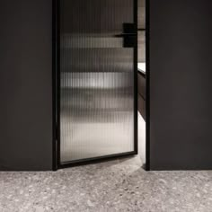 an open door leading into a room with black walls