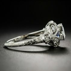 an antique style diamond ring with filigree accents