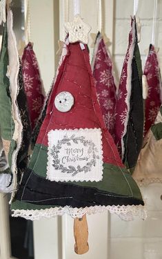 an ornament hanging from the ceiling in front of a white door with red and green decorations