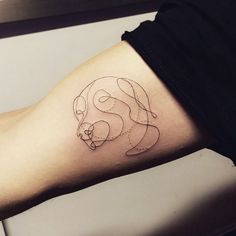 a woman's arm with a tattoo on it that has a bear and heart in the middle