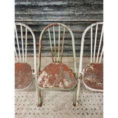 three old chairs sitting next to each other