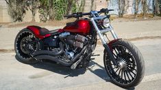 a red and black motorcycle parked on the street