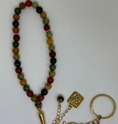 "This stunning Multicolor beaded sibha (prayer beads) features a beautiful and unique design. The beads are carefully crafted with a variety of colors, creating a beautiful and eye-catching pattern. The \"Subhan Allah\" pendant and key chain add a touch of elegance and sophistication to the Sibha, making it perfect for anyone who wants to add a touch of style to their prayer routine. Get your Multicolor beaded sibha now and add a touch of beauty and style to your prayer routine! The Sibha contains 33 beads." Traditional Beaded Bracelets With Round Beads For Blessing, Multicolor Polished Beaded Bracelets For Meditation, Multicolor Polished Beads Bracelet For Meditation, Hand-strung Multicolor Beads For Gifts, Multicolor Round Spiritual Beaded Necklaces, Spiritual Multicolor Round Beaded Necklaces, Spiritual Multicolor Beaded Bracelets, Multicolor Agate Beaded Bracelets With Colorful Beads, Traditional Multicolor 8mm Beads Jewelry