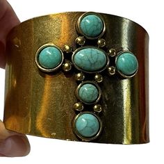 Style: Fashion Jewelry Type: Bracelet Cuff Color: Gold Tone Accent: Faux Turquoise Cross Width: 2.5" Enhance your accessory collection with this stunning Vintage Band Bracelet Cuff. Featuring a luxurious gold tone, this bracelet is adorned with a beautiful faux turquoise cross, adding a touch of elegance and color. With a width of 2.5 inches, it makes a bold statement while maintaining a classic vintage charm. Perfect for both casual and formal occasions, this unique cuff bracelet is a versatile piece that adds a stylish flair to any outfit. Embrace timeless beauty and sophistication with this exquisite vintage bracelet. Turquoise Metal Bangle Cuff Bracelet, Adjustable Turquoise Metal Cuff Bracelet, Bohemian Turquoise Metal Cuff Bracelet, Bohemian Cuff Jewelry As Fashion Accessory, Turquoise Cross, Vintage Bracelet, Band Bracelet, Bracelet Cuff, Vintage Band