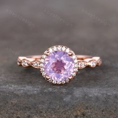 Handmade with natural lavender amethyst - a unique pale purple gemstone, and adorned with sparkly simulated diamonds, this gorgeous ring is meticulously crafted. This is a Vintage Engagement ring with Lavender Amethyst and Cubic Zircon. This ring is marked S925/G10K/G14K Main stone is 7mm Round Cut Natural Lavender Amethyst, halo stones are cubic zirconia. Best Gift for Engagement,wedding,birthday gift. I accept custom making order.Please contact me if you need this service. All the jewelry in m Elegant Purple Kunzite Ring, Pink Kunzite Jewelry For Wedding, Purple Birthstone Ring With Round Stone For Wedding, Pink Amethyst Birthstone Promise Ring, Purple Birthstone Ring For Wedding With Round Stone, Purple Birthstone Ring For Wedding, Pink Kunzite Wedding Rings, Elegant Pink Amethyst Wedding Ring, Elegant Lavender Birthstone Ring For Weddings