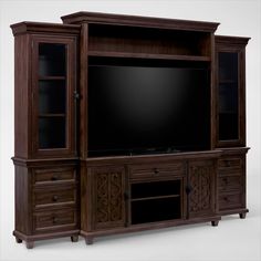 a large entertainment center with drawers and a flat screen tv