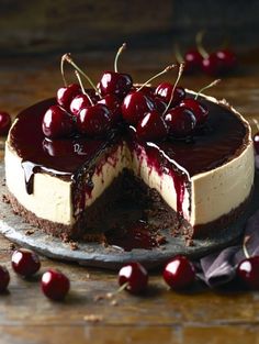 a cheesecake topped with cherries on a plate