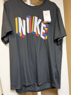 NEW MENS or Unisex size Large NIKE black short Sleeve Dri Fit training polyester blend fabric. Machine washable. Nike logo graphic on the front. Standard fit. New with tags. Adult Size Large Tee T Shirt NWT From a smoke free environment. We ship globally. No returns. Nike Art, Active Wear Tops, Nike Black, Logo Graphic, Nike Logo, Black Shorts, Nike Dri Fit, Black Nikes, Ncaa