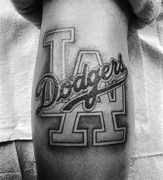 a black and white photo of a man's leg with the word dodger on it