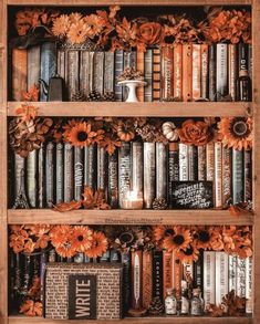 a book shelf filled with lots of books covered in orange flowers and fall foliages