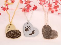 This heart shaped fingerprint necklace is a jewelry piece that will capture your heart and cherish your deepest connections like never before. This unique necklace allows you to engrave your own, or a loved one's fingerprint, footprint or handprint, elevating the sentimental value to new heights.  But, it gets even better! With the option to combine two fingerprints, you can create a heart-shaped masterpiece that symbolizes your everlasting love and unity. Handmade with love and meticulous craftsmanship, this personalized necklace is an exquisite testament to your most cherished relationships. Each pendant is delicately crafted to perfection, ensuring that every detail of your fingerprint is etched with precision and care. To add an extra touch of personalization, we offer the option to en Hand Stamped Heart Pendant Necklace For Keepsake, Keepsake Hand Stamped Heart Pendant Necklace, Keepsake Hand-stamped Heart Pendant Necklace, Hand Stamped Heart Necklace For Gift, Hand Stamped Necklaces For Valentine's Day Keepsake, Valentine's Day Keepsake Hand Stamped Necklaces, Heart-shaped Stamped Necklace For Personalized Gift, Personalized Heart-shaped Stamped Necklaces, Personalized Stamped Heart Necklace