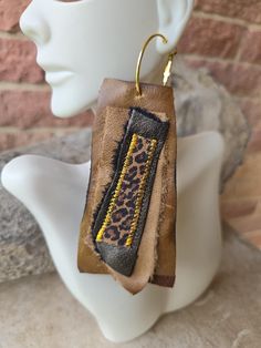 Handmade brown leather earrings with animal print accents Handmade Brown Earrings For Everyday Use, Brown Hoop Earrings With Ear Wire For Gift, Unique Brown Hoop Earrings For Gift, Brown Single Hoop Earring As Gift, Brown Hand Tooled Dangle Earrings, Hand Tooled Brown Dangle Earrings, Handmade Leather Hoop Earrings, Handmade Brown Hoop Earrings For Everyday Wear, Everyday Handmade Brown Hoop Earrings