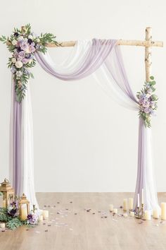 a wedding arch decorated with flowers and candles