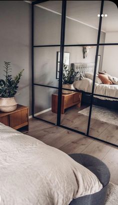 a bedroom with mirrored walls and wooden floors