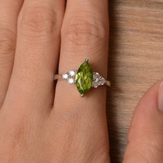 It is a natural peridot ring. The main stone is 6mm*12mm marquise cut, weight about 1.55 carats. The basic metal is sterling silver and plated with rhodium. To change the metal to a solid gold (white/rose) or platinum is also available, please ask for a quotation if you want. You can also go to my shop Home for more elegant rings: https://www.etsy.com/shop/godjewelry?ref=hdr_shop_menu More peridot rings: https://www.etsy.com/shop/godjewelry?section_id=20709252 Customization is always welcome and Green Marquise Diamond Promise Ring, Green Marquise Diamond Ring, Green Marquise Cut Promise Ring, Marquise Cut Diamond Ring For May Birthstone, Green Marquise Sterling Silver Jewelry, Green Marquise Birthstone Jewelry, Marquise Cut May Birthstone Ring Gift, May Birthstone Ring As Gift, Marquise Cut, Green Marquise Birthstone Ring