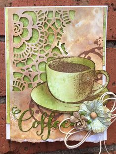 a close up of a cup of coffee on a brick wall with a paper doily