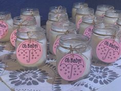 there are many mason jars with pink labels on them and one is labeled oh baby