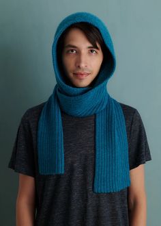 a young man wearing a blue scarf and hood