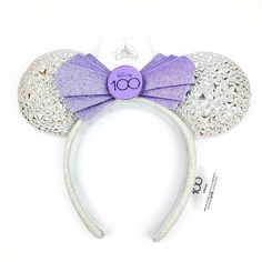 Disney Minnie Mouse Ears Headband Adults 100 Years Of Wonder Disney 100 Sparkle Silver With Purple Adornment. Available In One Size For Adult Or Child. Embroidered In Purple ‘Disney Cast Member’ Along Side Of Headband. Exclusive And Limited Cast Member Ears! Minnie Mouse Disney100 Ear Headband For Adults Soft Padded Minnie Mouse Ears Lurex Ears Accented With Platinum Colored Appliqus Glittering Purple Bow With Metal Disney100 Logo Centerpiece Lurex Headband Exterior Contrast Non-Slip Velour Inte Disney Minnie Mouse Ears, Disney Cast Member, Disney Cast, Minnie Mouse Ears Headband, Disney 100, Purple Bow, Mouse Ears Headband, Purple Bows, Ears Headband