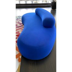 a blue couch sitting on top of a wooden floor