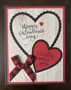 a valentine's day card with two hearts and a bow on the front that says happy valentine's day