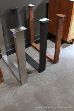 three different types of metal and wood standing on carpeted floor next to each other