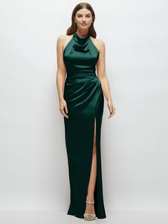 a woman in a long green dress with a slited skirt and high neckline