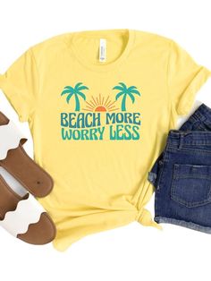 Introducing the Beach More Worry Less Women's Graphic T-Shirt, the perfect addition to your summer wardrobe. Available in 8 colors and sizes XS-XXXL, this t-shirt is perfect for every woman. Its comfortable and stylish design make it perfect for vacations, beach days, and more. Made from high-quality materials, this t-shirt is soft, comfortable, and lightweight, ensuring your comfort during hot summer days. Its fun and playful graphic design encourages you to embrace the carefree spirit of summe Casual Yellow T-shirt For Vacation, Yellow Beachy Top For Vacation, Yellow Crew Neck T-shirt For Beach, Vacation Cotton T-shirt With Text Print, Yellow Crew Neck Top For Beach Season, Beachy Vacation T-shirt With Text Print, Yellow Summer T-shirt For Beach Season, Yellow Graphic Print Top For Beach Season, Yellow Crew Neck Top For Beach