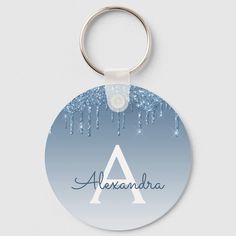 a blue and white keychain with the word alexandria on it's front