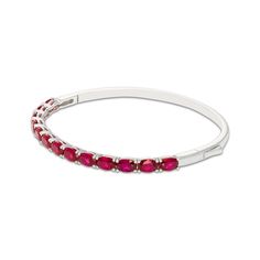 You'll love the bright color and sleek set of this lab-created ruby bangle bracelet. Sterling silver Oval-cut lab-created rubies are set horizontally along the front of the bangle 7-inch circumference Hinged with box clasp Kays Engagement Ring, Gold Layered Bracelets, Neil Lane Engagement Rings, Pearl Diamond Jewelry, Ruby Bangles, Cross Jewelry Necklace, Fan Jewelry, Bezel Engagement Ring, Diamond Wedding Rings Sets