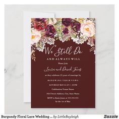 an elegant wedding card with flowers and leaves on the front, in navy blue background