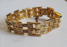 Double row geometric design damascene bracelet. Becoming increasingly hard to find. Clips securely with a safety chain. Typical black and gold decoration in lovely condition with slight wear. Approx 19 cm long and 1.5 cm wide. Will be carefully wrapped and packaged in an organza gift bag. Gold Etched Metal Bracelets, Art Deco Gold Engraved Bracelet, Art Deco Engraved Gold Bracelets, Vintage Dragonfly, Filigree Bracelet, Bohemian Jewellery, Safety Chain, Gold Decor, Organza Gift Bags