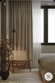 a bed room with a neatly made bed and a chair next to a large window