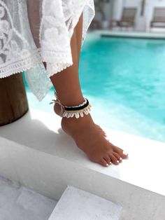 This exquisite Boho Cowrie Shell Ankle Bracelet is a summer essential for those who love a touch of the ocean in their style. Handcrafted meticulously, this anklet features authentic cowrie shells, symbolizing protection and strength, paired with fine beads that enhance its aesthetic appeal. Perfect for beach days or a casual sunny outing, this ankle bracelet embraces the spirit of summer with its natural, bohemian vibe. Its adjustable design ensures it fits comfortably around any ankle, making White Ankle Wrap Anklets For Beach, Summer Beach Beaded Bracelets, Beachy Bracelets For Summer Vacation, Beachy Summer Bracelets For Vacation, Summer Beaded Bracelets For Beach, Beaded Strand Anklets For Vacation, Beaded Ankle Wrap Anklets For Beach, Bohemian Friendship Bracelets For Beach Summer, Summer Festival Beaded Bracelets