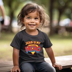 "Transform your little one into a super hero with our Jesus Is My Hero Toddler Tee! Made with a soft and comfortable Bella Canvas brand, this unisex fit shirt will inspire your child to be a proud Christian. Quality guaranteed for your little hero!" Christian Kids Shirts, White Jesus, Black Jesus, Jesus Tees, Country Clothing, Christian Kids, Christian Apparel, Columbia Blue, Toddler Tees